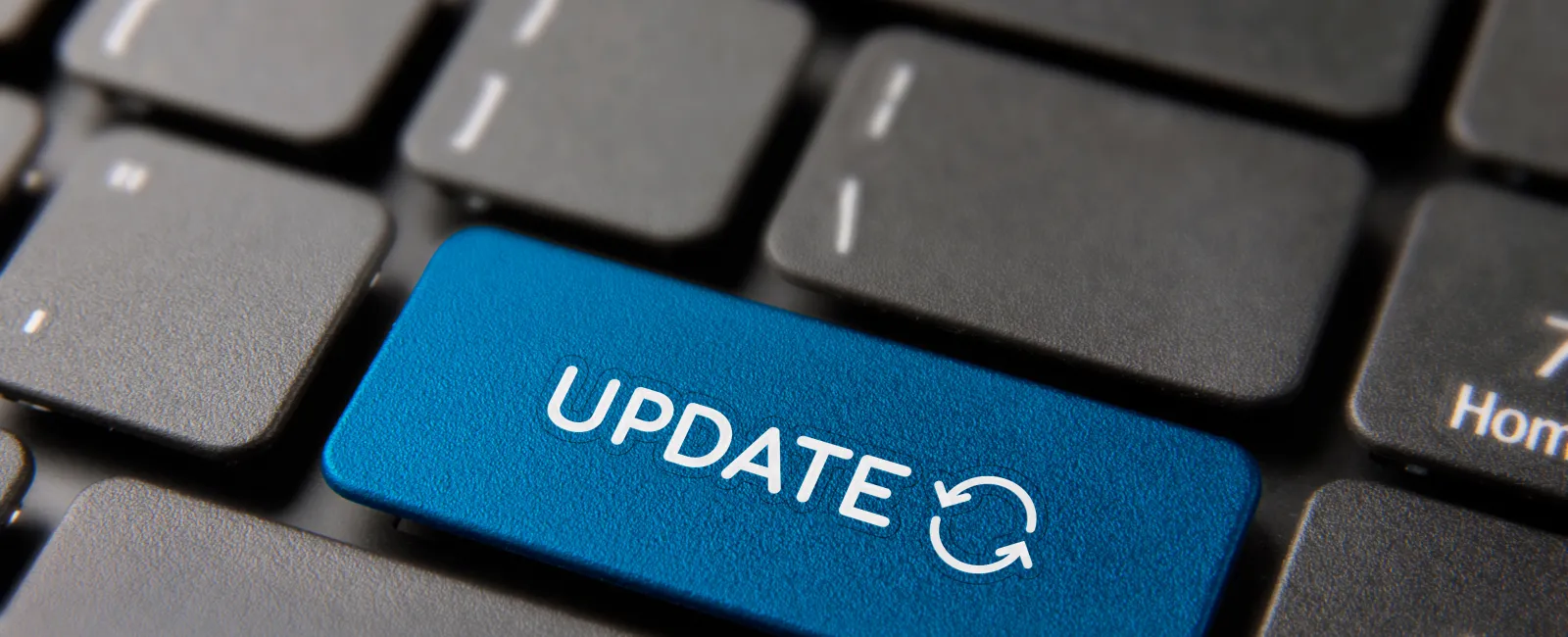 Close-up of a blue keyboard key labeled 'UPDATE' with a refresh symbol, emphasizing software updates.